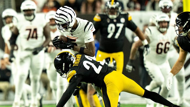Pittsburgh Steelers safety Juan Thornhill (22) tackles Cincinnati Bengals wide receiver Tee Higgins (5) in the first quarter of the NFL game between the Cincinnati Bengals and Pittsburgh Steelers at Paycor Stadium in Cincinnati on Oct. 16, 2025. Pittsburgh Steelers safety Juan Thornhill (22) tackles Cincinnati Bengals wide receiver Tee Higgins (5) in the first quarter of the NFL game between the Cincinnati Bengals and Pittsburgh Steelers at Paycor Stadium in Cincinnati on Oct. 16, 2025.