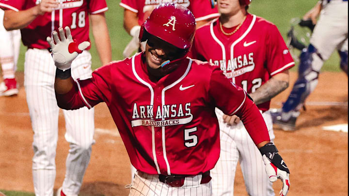 Arkansas third baseman TJ Pompey celebrates a home run against Central Arkansas at Baum-Walker Stadium.