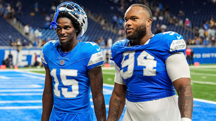 Detroit Lions cornerback Ennis Rakestraw Jr. (15), left, talks to defensive tackle Mekhi Wingo (94) 