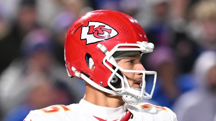 Nov 2, 2025; Orchard Park, New York, USA; Kansas City Chiefs quarterback Patrick Mahomes (15) looks for an open receiver while under pressure from Buffalo Bills defensive end A.J. Epenesa (57) in the second half at Highmark Stadium. Mandatory Credit: Mark Konezny-Imagn Images