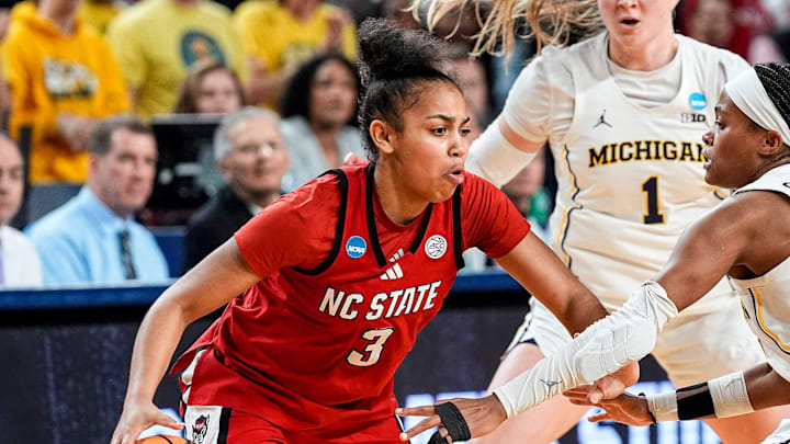 Michigan guard Brooke Q. Daniels (5) and guard Olivia Olson (1) defends N.C. State guard Zamareya Jones (3) during the second half of NCAA Tournament Second Round at Crisler Center in Ann Arbor on Sunday, March 22, 2026.