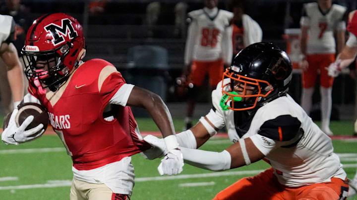 Cardinal Mooney ball carrier Marcus Galloway (#4) is stopped when Cocoa High defensive back CJ Hester (#1) grabs his jersey. Cocoa High School defeated Cardinal Mooney Catholic High School 31-21 to win the Class 2A semi-final game Friday night in Sarasota. Cardinal Mooney ball carrier Marcus Galloway (#4) is stopped when Cocoa High defensive back CJ Hester (#1) grabs his jersey. Cocoa High School defeated Cardinal Mooney Catholic High School 31-21 to win the Class 2A semi-final game Friday night in Sarasota.