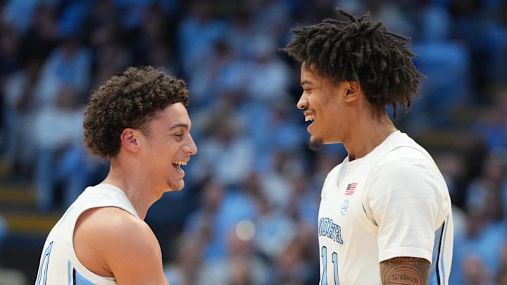 Feb 2, 2026; Chapel Hill, North Carolina, USA;  North Carolina Tar Heels guard Kyan Evans (0) and forward Jonathan Powell (11) react in the first half at Dean E. Smith Center. Mandatory Credit: Bob Donnan-Imagn Images