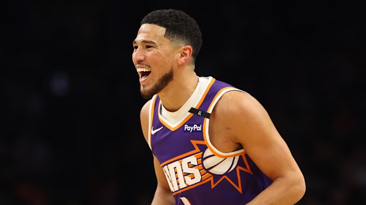 Mar 24, 2025; Phoenix, Arizona, USA; Phoenix Suns guard Devin Booker (1) reacts against the Milwaukee Bucks at Footprint Center. Mandatory Credit: Mark J. Rebilas-Imagn Images