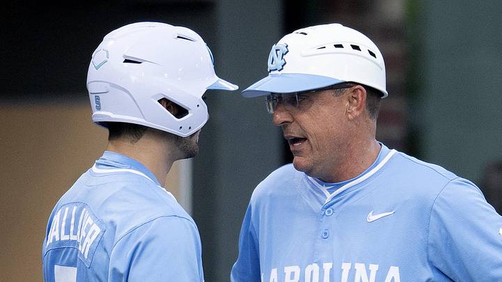 Jun 3, 2024; Chapel Hill, NC, USA; North Carolina Tar Heels Gavin Gallaher (5) and head coach Scott Forbes (21) talk before batting in the sixth inning of the Div. I NCAA baseball regional against the Louisiana State Tigers at Boshamer Stadium. Mandatory Credit: Jeffrey Camarati-Imagn Images
Jun 3, 2024; Chapel Hill, NC, USA; North Carolina Tar Heels Gavin Gallaher (5) and head coach Scott Forbes (21) talk before batting in the sixth inning of the Div. I NCAA baseball regional against the Louisiana State Tigers at Boshamer Stadium. Mandatory Credit: Jeffrey Camarati-Imagn Images