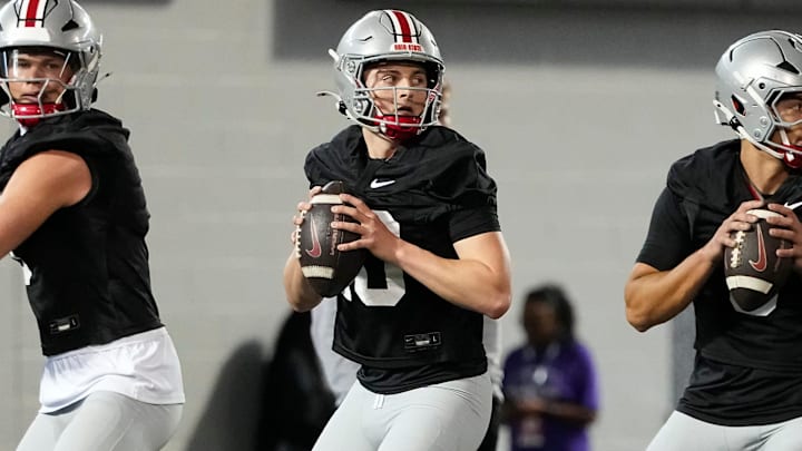 From left, Ohio State Buckeyes quarterbacks Lincoln Kienholz (3), Julian Sayin (10) and Tavien St. Clair (9) drop back to pass during spring football practice at the Woody Hayes Athletic Center in Columbus on March 19, 2025.