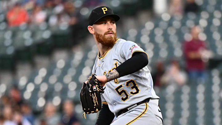 Pittsburgh Pirates pitcher Mike Burrows throws a baseball in a gray uniform and black hat