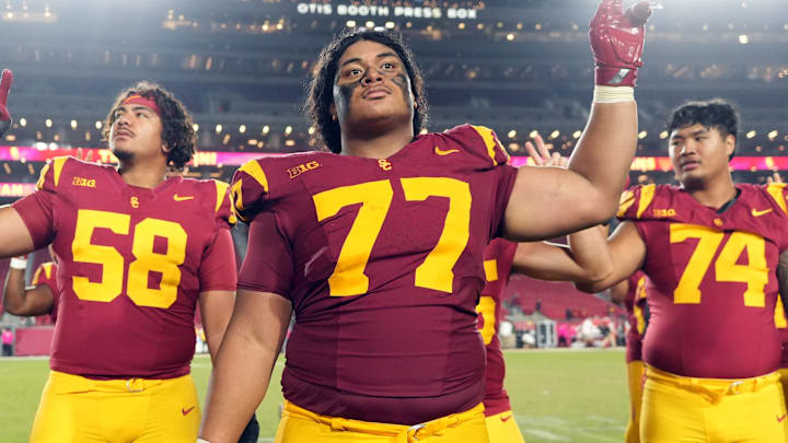 Oct 25, 2024; Los Angeles, California, USA; Southern California Trojans offensive lineman Alani Noa (77) celebrates with teammates after the game against the Rutgers Scarlet Knights at United Airlines Field at Los Angeles Memorial Coliseum. Mandatory Credit: Kirby Lee-Imagn Images