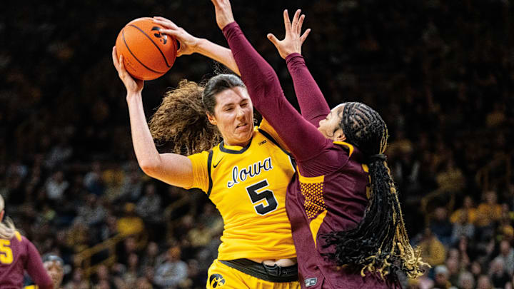 Iowa center Ava Heiden (5) keeps possession of the ball against Minnesota forward Finau Tonga (31) on Feb. 5, 2026, at Carver-Hawkeye Arena.