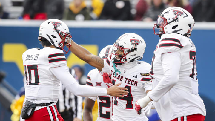 Texas Tech Red Raiders wide receiver Micah Hudson (14) celebrates a touchdown catch with Texas Tech Red Raiders quarterback Lloyd Jones III (10) during the third quarter against the West Virginia Mountaineers at Milan Puskar Stadium.