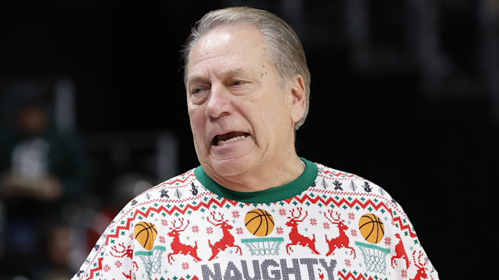 Michigan State Spartans head coach Tom Izzo patrols the sidelines wearing an ugly Christmas sweater depicting him yelling at a referee with "Naughty List" written on it during a game against the Oakland Golden Grizzlies at Little Caesars Arena on Saturday, Dec. 20, 2025.