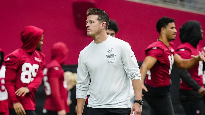 Cardinals head coach Mike LaFleur walks the field as players warm up during training camp at State Farm Stadium in Glendale on July 30, 2026. Cardinals head coach Mike LaFleur walks the field as players warm up during training camp at State Farm Stadium in Glendale on July 30, 2026.