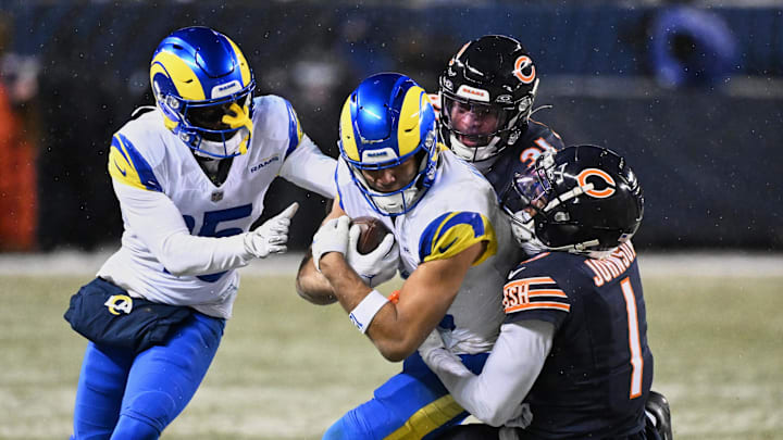 Jan 18, 2026; Chicago, IL, USA; Los Angeles Rams wide receiver Puka Nacua (12) runs after the catch against Chicago Bears cornerback Jaylon Johnson (1) during overtime of an NFC Divisional Round game at Soldier Field. Mandatory Credit: Matt Marton-Imagn Images