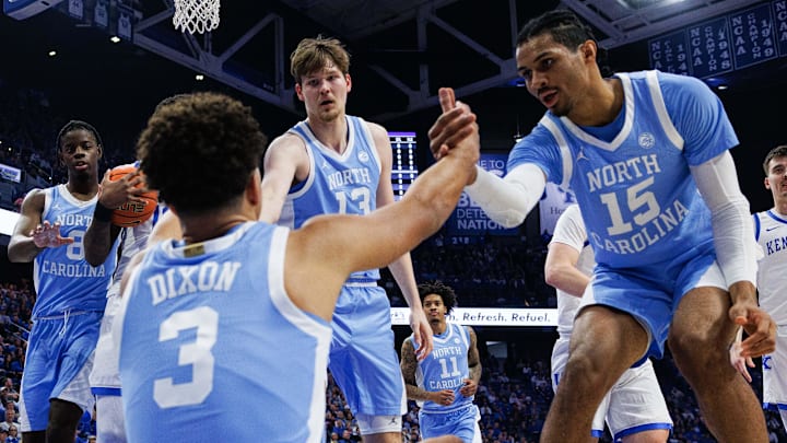 Dec 2, 2025; Lexington, Kentucky, USA; North Carolina Tar Heels guard Derek Dixon (3) is helped to his feet by center Henri Veesaar (13) and forward Jarin Stevenson (15) during the first half against the Kentucky Wildcats at Rupp Arena at Central Bank Center. Mandatory Credit: Jordan Prather-Imagn Images Dec 2, 2025; Lexington, Kentucky, USA; North Carolina Tar Heels guard Derek Dixon (3) is helped to his feet by center Henri Veesaar (13) and forward Jarin Stevenson (15) during the first half against the Kentucky Wildcats at Rupp Arena at Central Bank Center. Mandatory Credit: Jordan Prather-Imagn Images