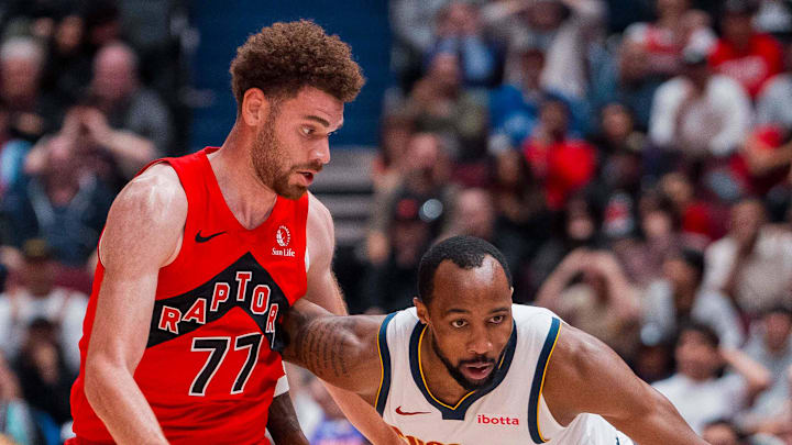 Denver Nuggets guard Tamar Bates drives past Toronto Raptors forward Jamison Battle. Denver Nuggets guard Tamar Bates drives past Toronto Raptors forward Jamison Battle.