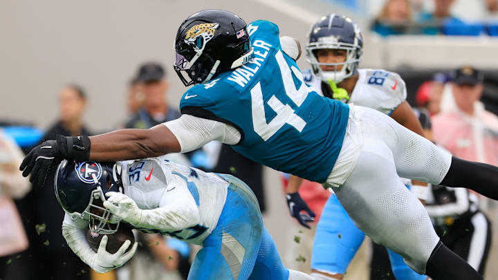 Jacksonville Jaguars defensive end Travon Walker (44) and cornerback Jarrian Jones (22) combine to tackle Tennessee Titans running back Julius Chestnut (36) during the fourth quarter Sunday, Dec. 29, 2024 at EverBank Stadium in Jacksonville, Fla. The Jaguars held off the Titans 20-13. [Corey Perrine/Florida Times-Union]