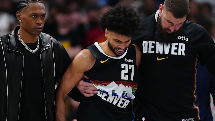 Mar 6, 2026; Denver, Colorado, USA; Denver Nuggets guard Jamal Murray (27) is helped off the court by guard Peyton Watson (8) and center Jonas Valanciunas (17) during the second quarter against the New York Knicks at Ball Arena.