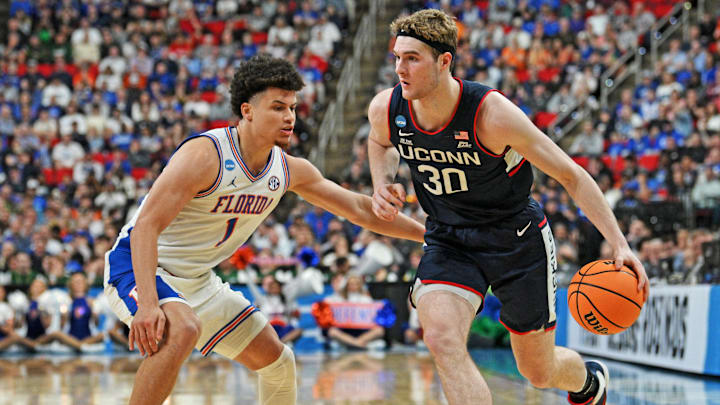Mar 23, 2025; Raleigh, NC, USA; Connecticut Huskies forward Liam McNeeley (30) drives to the basket during the second half against Florida Gators guard Walter Clayton Jr. (1) in the second round of the NCAA Tournament at Lenovo Center. Mandatory Credit: Zachary Taft-Imagn Images Mar 23, 2025; Raleigh, NC, USA; Connecticut Huskies forward Liam McNeeley (30) drives to the basket during the second half against Florida Gators guard Walter Clayton Jr. (1) in the second round of the NCAA Tournament at Lenovo Center. Mandatory Credit: Zachary Taft-Imagn Images