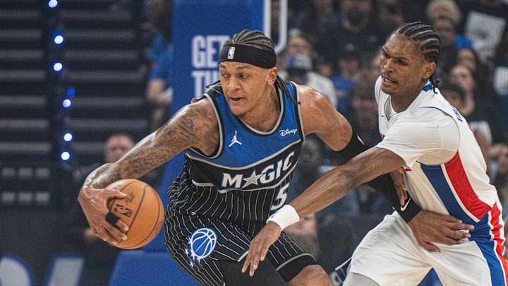 May 1, 2026; Orlando, Florida, USA; Orlando Magic forward Paolo Banchero (5) dribbles the ball against Detroit Pistons guard-forward Ausar Thompson (9) in the first quarter during game six of the first round of the 2026 NBA Playoffs at Kia Center. Mandatory Credit: Jeremy Reper-Imagn Images