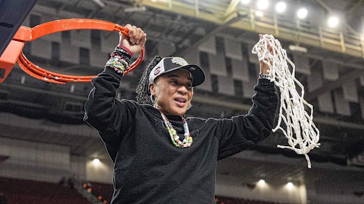 South Carolina coach Dawn Staley cuts down the nets after the team won the SEC.
