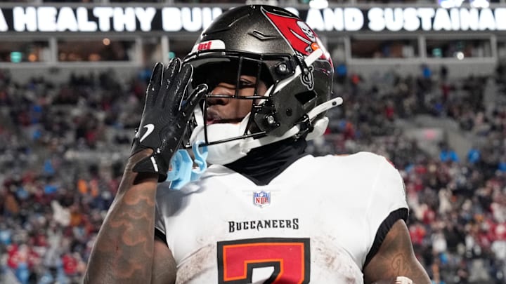 Dec 1, 2024; Charlotte, North Carolina, USA; Tampa Bay Buccaneers running back Bucky Irving (7) blows a kiss to the crowd after scoring a touchdown in the fourth quarter at Bank of America Stadium. Mandatory Credit: Bob Donnan-Imagn Images