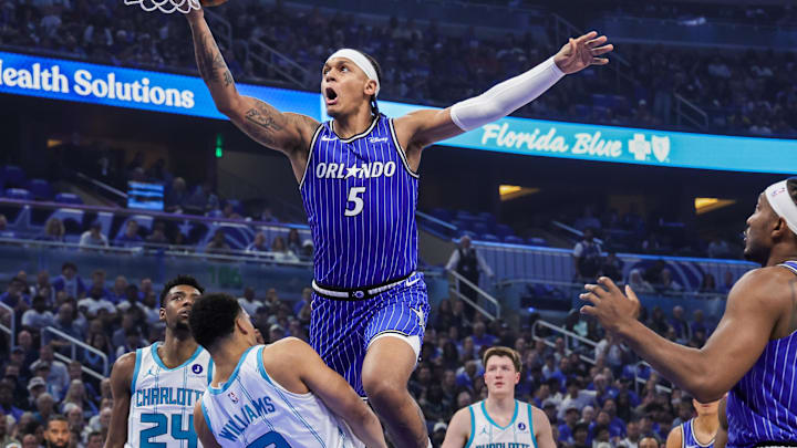 Apr 17, 2026; Orlando, Florida, USA; Charlotte Hornets forward Grant Williams (2) is fouled by Orlando Magic forward Paolo Banchero (5) during the second quarter during the play-in rounds of the 2026 NBA Playoffs at Kia Center. Mandatory Credit: Mike Watters-Imagn Images
