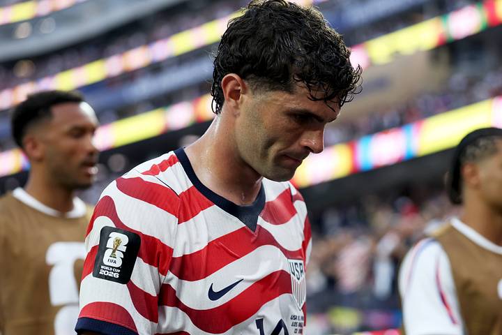 Christian Pulisic with his head bowed. Christian Pulisic with his head bowed.