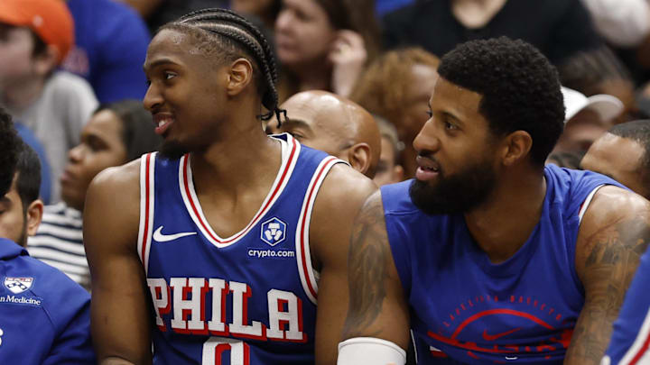 Apr 1, 2026; Washington, District of Columbia, USA; Philadelphia 76ers guard Tyrese Maxey (0) and 76ers forward Paul George (8) look on from the bench against the Washington Wizards in the second half at Capital One Arena. Mandatory Credit: Geoff Burke-Imagn Images