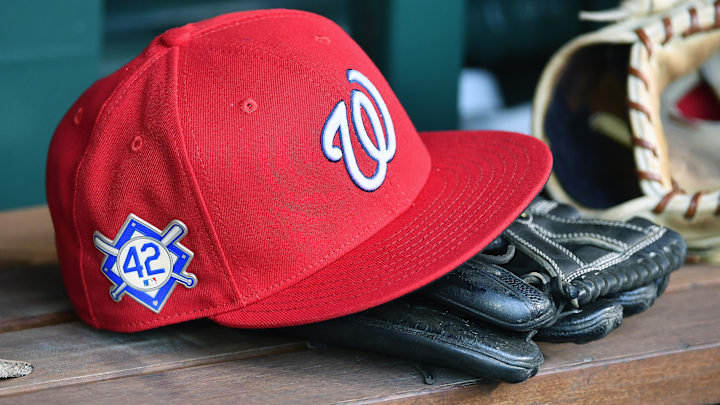 Red Washington Nationals hat on top of a black mitt
