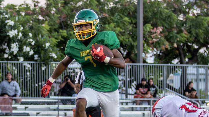 Kaimuki's Tieler Sufon sprints away from a Waialua defender for one of his three touchdowns Thursday night. Kaimuki's Tieler Sufon sprints away from a Waialua defender for one of his three touchdowns Thursday night.