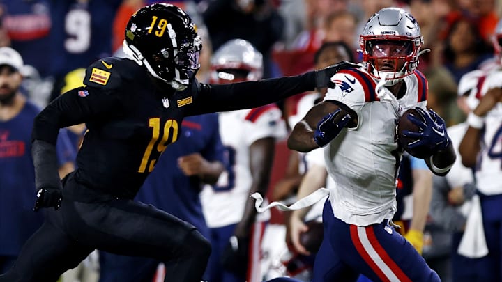 New England Patriots wide receiver Ja'Lynn Polk (1) runs after a catch against Washington Commanders cornerback Noah Igbinoghene (19) during the first quarter during a preseason game at Commanders Field. 