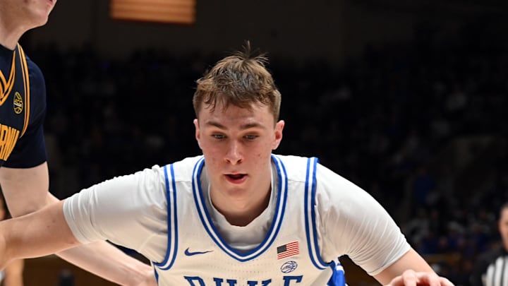 Feb 12, 2025; Durham, North Carolina, USA; Duke Blue Devils forward Cooper Flagg (2) controls the ball in front of California Golden Bears forward Rytis Petraitis (31) during the second half at Cameron Indoor Stadium. Mandatory Credit: Rob Kinnan-Imagn Images