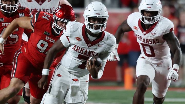 Arkansas Razorbacks quarterback KJ Jackson (7) runs the ball against Utah Utes defensive tackle Mike Tauteoli (94) during the second quarter at Rice-Eccles Stadium. Arkansas Razorbacks quarterback KJ Jackson (7) runs the ball against Utah Utes defensive tackle Mike Tauteoli (94) during the second quarter at Rice-Eccles Stadium.
