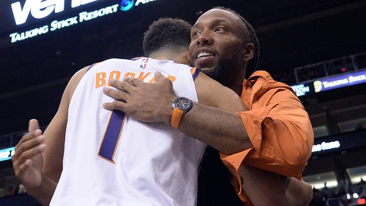 Feb 12, 2020; Phoenix, Arizona, USA; Phoenix Suns guard Devin Booker (1) hugs Arizona Cardinals wide receiver Larry Fitzgerald during the first half of the game against the Golden State Warriors at Talking Stick Resort Arena. Mandatory Credit: Joe Camporeale-USA TODAY Sports Feb 12, 2020; Phoenix, Arizona, USA; Phoenix Suns guard Devin Booker (1) hugs Arizona Cardinals wide receiver Larry Fitzgerald during the first half of the game against the Golden State Warriors at Talking Stick Resort Arena. Mandatory Credit: Joe Camporeale-USA TODAY Sports