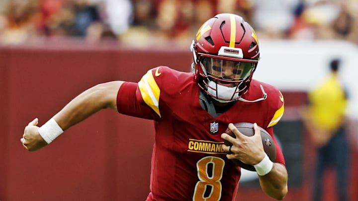 Washington Commanders quarterback Marcus Mariota runs the ball during the first half against the Las Vegas Raiders.