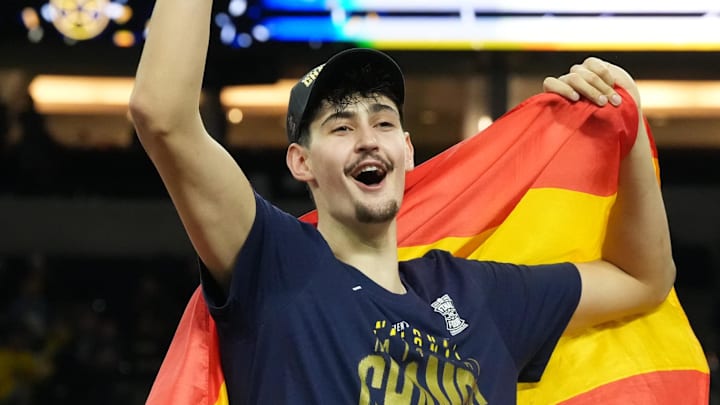 Apr 6, 2026; Indianapolis, IN, USA; Michigan Wolverines center Aday Mara (15) celebrates after cutting down a piece of the net after defeating the Connecticut Huskies in the national championship of the Final Four of the men's 2026 NCAA Tournament at Lucas Oil Stadium. Mandatory Credit: Robert Deutsch-Imagn Images