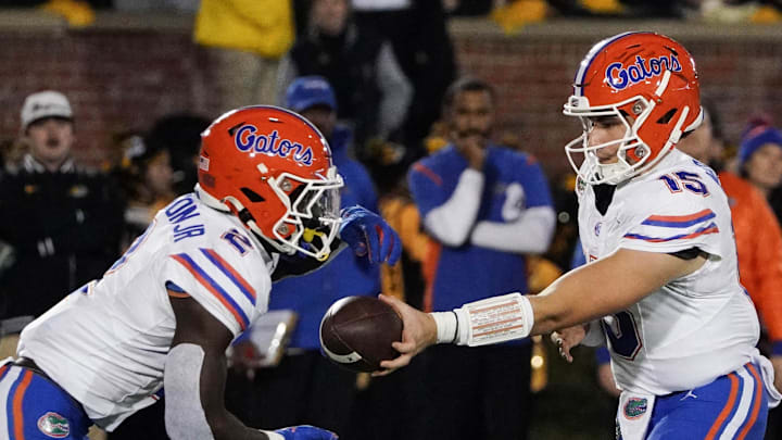 Nov 18, 2023; Columbia, Missouri, USA; Florida Gators quarterback Graham Mertz (15) hands off to running back Montrell Johnson Jr. (2) against the Missouri Tigers during the game at Faurot Field at Memorial Stadium. Mandatory Credit: Denny Medley-Imagn Images Nov 18, 2023; Columbia, Missouri, USA; Florida Gators quarterback Graham Mertz (15) hands off to running back Montrell Johnson Jr. (2) against the Missouri Tigers during the game at Faurot Field at Memorial Stadium. Mandatory Credit: Denny Medley-Imagn Images