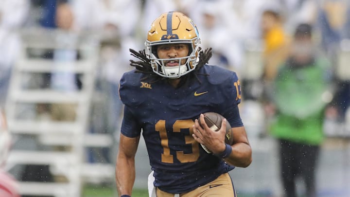 Sep 27, 2025; Morgantown, West Virginia, USA; West Virginia Mountaineers quarterback Jaylen Henderson (13) runs the ball during the first quarter against the Utah Utes at Milan Puskar Stadium. Mandatory Credit: Ben Queen-Imagn Images