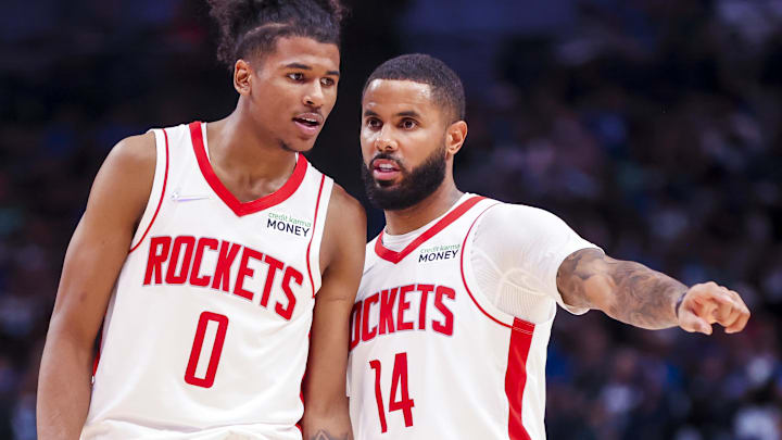 Former Houston Rockets guard D.J. Augustin (14) and guard Jalen Green (0) talk during the fourth quarter against the Dallas Mavericks at American Airlines Center.