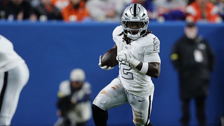 Nov 6, 2025; Denver, Colorado, USA; Las Vegas Raiders running back Ashton Jeanty (2) rushes the ball against the Denver Broncos during the first half at Empower Field at Mile High. Mandatory Credit: Isaiah J. Downing-Imagn Images