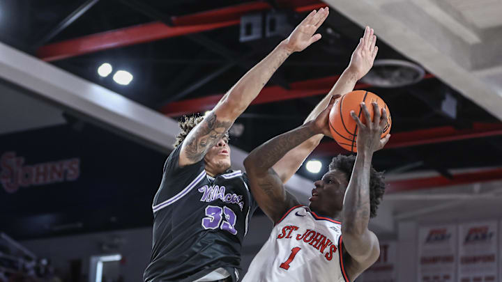Dec 7, 2024; Queens, New York, USA;  St. John's Red Storm guard Kadary Richmond (1) looks to drive past Kansas State Wildcats guard Coleman Hawkins (33) in the second half at Carnesecca Arena. Mandatory Credit: Wendell Cruz-Imagn Images