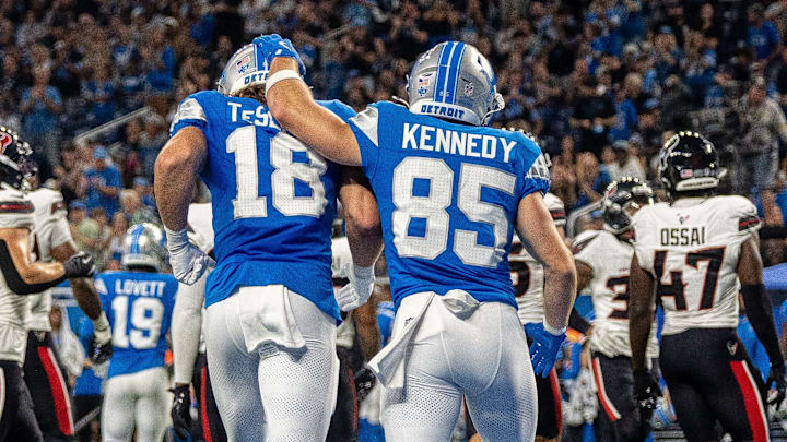 Detroit Lions wide receiver Isaac TeSlaa (18) walks off the field alongside fellow wide receiver Tom Kennedy (85)