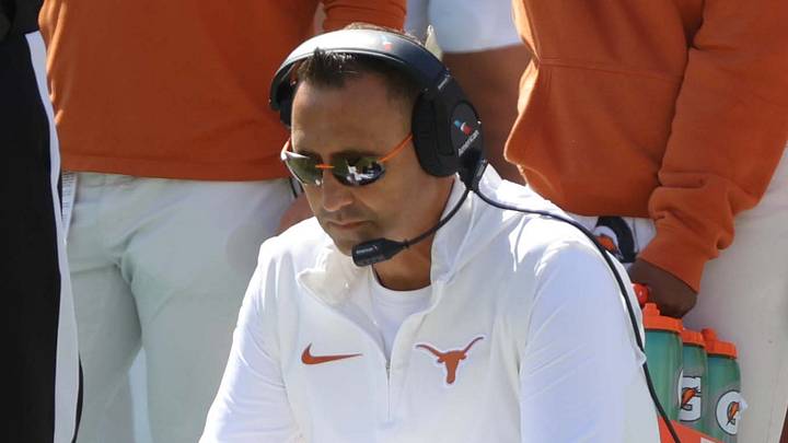 Steve Sarkisian kneels on the sideline during the Red River Rivalry college football game between the University of Oklahoma Sooners (OU) and the University of Texas (UT) Longhorns at the Cotton Bowl in Dallas, Saturday, Oct. 7, 2023. Oklahoma won 34-30.