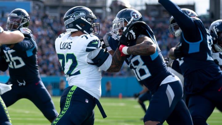 Seattle Seahawks offensive tackle Abraham Lucas (72) and Tennessee Titans linebacker Harold Landry III (58) battle during their game at Nissan Stadium in Nashville, Tenn., Sunday, Dec. 24, 2023.