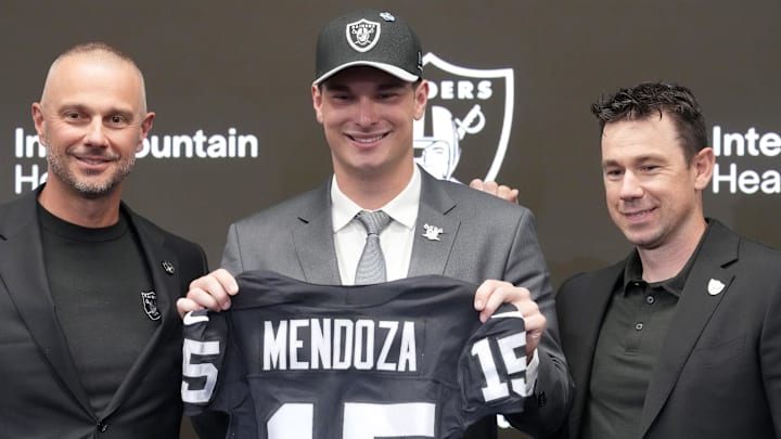 Apr 24, 2026; Henderson, NV, USA; Las Vegas Raiders quarterback Fernando Mendoza (center) poses with general manager John Spytek (left) and head coach Klint Kubiak  at introductory press conference at Intermountain Health Performance Center after being selected as the No. 1 pick in the 2026 NFL Draft. Mandatory Credit: Kirby Lee-Imagn Images