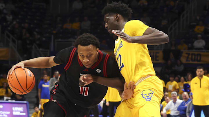 Jan 24, 2026; Pittsburgh, Pennsylvania, USA;  NC State Wolfpack guard Quadir Copeland (11) drives to the basket as Pittsburgh Panthers guard Barry Dunning Jr. (22) defends during the second half at the Petersen Events Center. Mandatory Credit: Charles LeClaire-Imagn Images