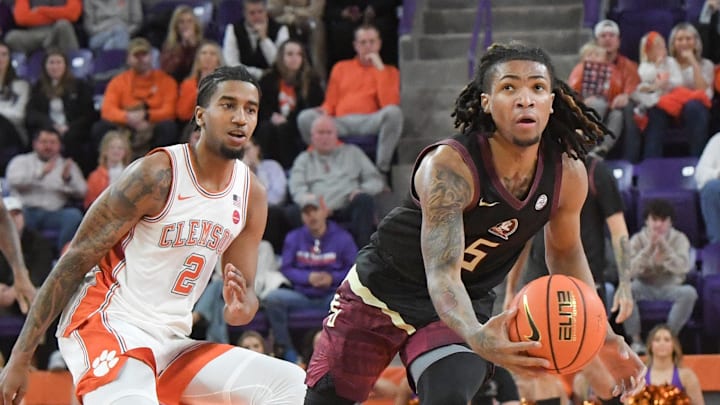 Jan 11, 2025; Clemson, South Carolina, USA; Florida State Seminoles guard Daquan Davis (5) grabs a loose ball against Clemson Tigers guard Dillon Hunter (2) during the first half at Littlejohn Coliseum. Mandatory Credit: Ken Ruinard/USA TODAY Network via Imagn Images