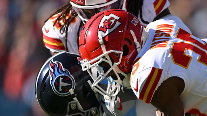 Dec 21, 2025; Nashville, Tennessee, USA; Kansas City Chiefs linebacker Nick Bolton (32) and cornerback Jaylen Watson (35) tackle Tennessee Titans wide receiver Van Jefferson (11) during the first half at Nissan Stadium. Mandatory Credit: Steve Roberts-Imagn Images
