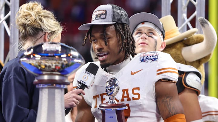 Jan 1, 2025; Atlanta, GA, USA; Texas Longhorns defensive back Jahdae Barron (7) receives the most outstanding player award after a victory over the Arizona State Sun Devils in the Peach Bowl at Mercedes-Benz Stadium. Mandatory Credit: Brett Davis-Imagn Images Jan 1, 2025; Atlanta, GA, USA; Texas Longhorns defensive back Jahdae Barron (7) receives the most outstanding player award after a victory over the Arizona State Sun Devils in the Peach Bowl at Mercedes-Benz Stadium. Mandatory Credit: Brett Davis-Imagn Images