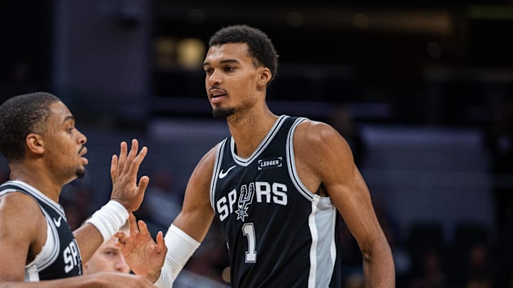 Oct 13, 2025; Indianapolis, Indiana, USA; San Antonio Spurs forward/guard Keldon Johnson (3) and forward/center Victor Wembanyama (1) celebrate a made basket in the second half against the Indiana Pacers at Gainbridge Fieldhouse. Mandatory Credit: Trevor Ruszkowski-Imagn Images